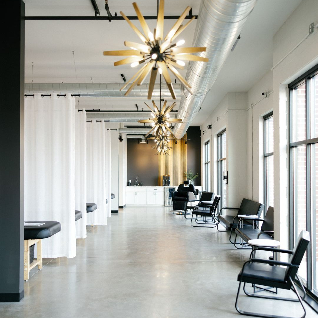 Modern office interior with stylish chandeliers and a long table.