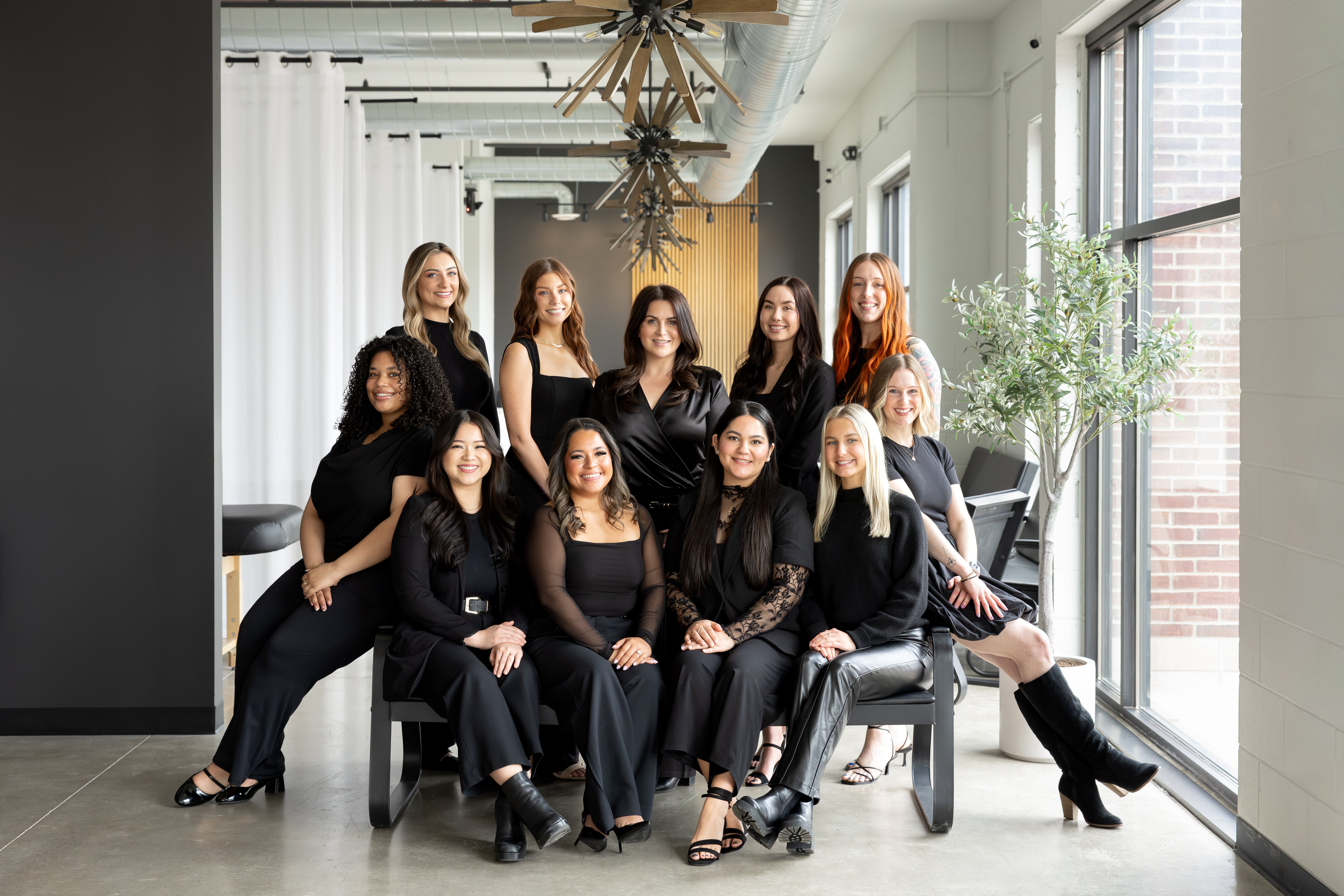Group of women posing together in a modern office setting