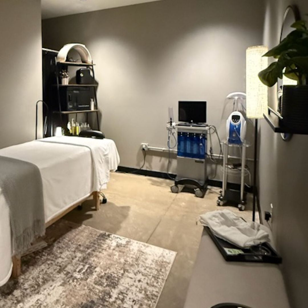 Modern medical or therapy room with equipment and a bed.
