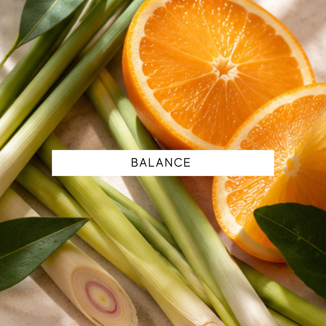 Sliced oranges and lemongrass with the word 'BALANCE' on a light background