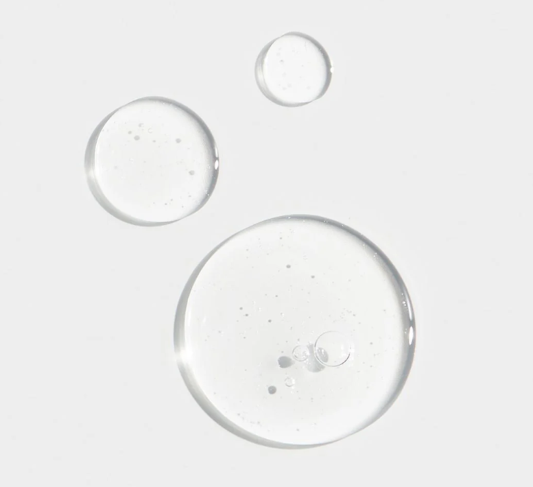 Clear liquid droplets on a light gray background